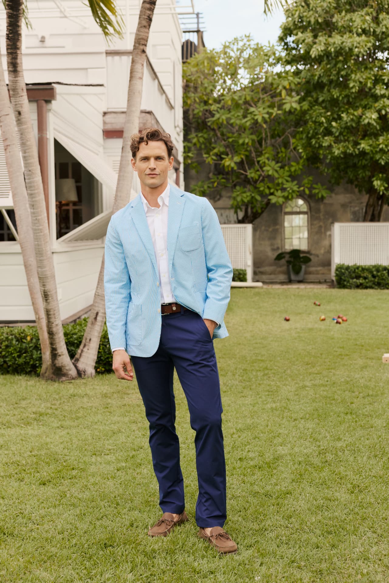 Man in a light blue seersucker sport coat with navy trousers
