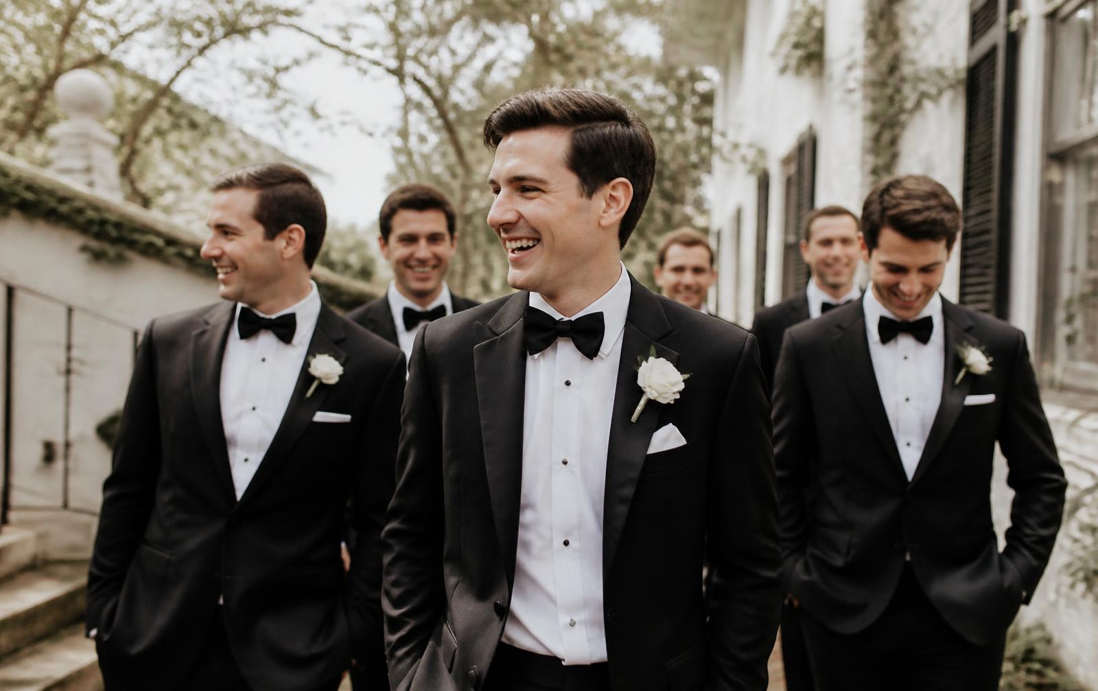 Stock photograph of a groom and groomsmen in black tuxedos